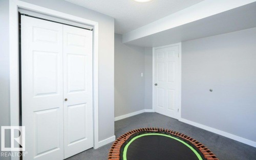 Room featuring light gray walls, gray carpeting, and white baseboards - 10812 109 Street, Westlock, AB - Indoor Photo Showing Other Room