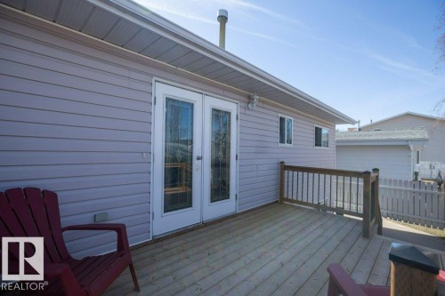 Spacious outdoor deck featuring wood flooring and a perimeter railing - 10812 109 Street, Westlock, AB - Outdoor With Deck Patio Veranda With Exterior