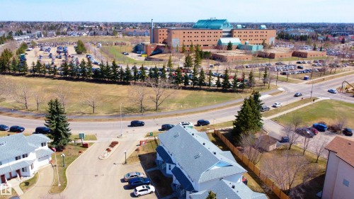 Residential structures featuring light-colored siding and dark roofing - #63 1033 Youville Dr W Nw, Edmonton, AB - Outdoor With View