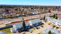 Townhouse community with multiple units, each featuring a private entrance and individual garage - 