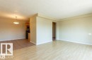 Open-concept living space featuring wood-finish flooring, a neutral color palette, and a semi-flush mount ceiling fixture - 307 8215 83 Avenue, Edmonton, AB  - Indoor Photo Showing Other Room 