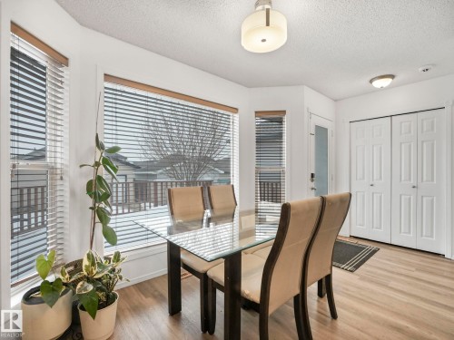 The property features a dining area with large windows, providing natural light - 21360 88 Avenue, Edmonton, AB - Indoor Photo Showing Dining Room