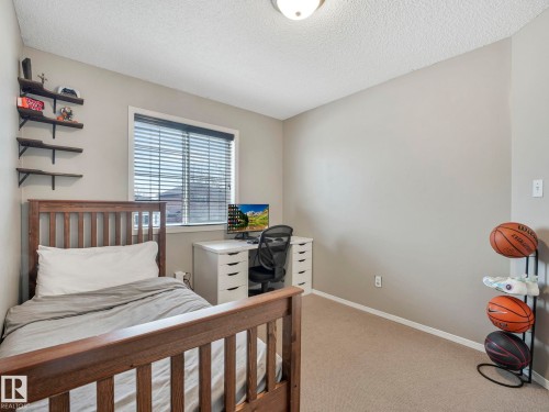 Bedroom featuring neutral-toned walls, carpeted flooring, and a window with blinds providing natural light - 21360 88 Avenue, Edmonton, AB - Indoor Photo Showing Bedroom