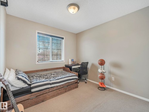 This room features a window with horizontal blinds, carpeted flooring, and light-colored walls - 21360 88 Avenue, Edmonton, AB - Indoor Photo Showing Bedroom