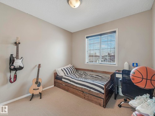 This room features a window with blinds, light-colored walls, and carpeting - 21360 88 Avenue, Edmonton, AB - Indoor Photo Showing Bedroom