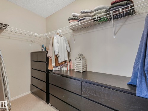 The property includes a closet with white wire shelving and a dark wood dresser system - 21360 88 Avenue, Edmonton, AB - Indoor With Storage