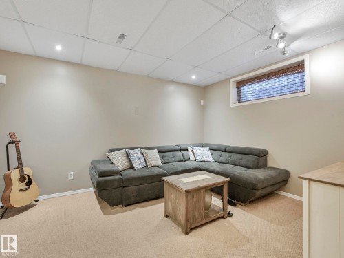 This inviting space features light beige walls, recessed lighting, and a window with blinds - 21360 88 Avenue, Edmonton, AB - Indoor Photo Showing Basement