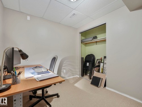 This space features carpeting, light-colored walls, and a ceiling with a textured finish - 21360 88 Avenue, Edmonton, AB - Indoor Photo Showing Office