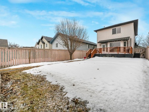 The property features a fenced yard with a deck and stairs providing direct exterior access - 21360 88 Avenue, Edmonton, AB - Outdoor