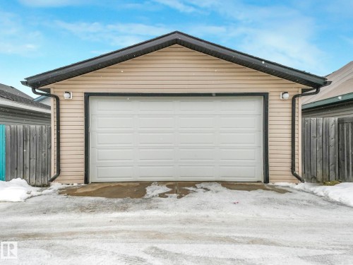 The property includes a detached garage featuring horizontal siding and a white panel garage door - 21360 88 Avenue, Edmonton, AB - Outdoor With Exterior
