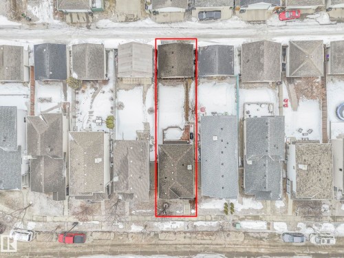 This aerial view showcases the property, highlighted by a red outline, situated within a neighborhood of residential structures - 21360 88 Avenue, Edmonton, AB - Other