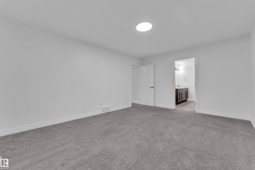 Spacious room featuring gray carpeting and white baseboards - 3235 13 Avenue, Edmonton, AB - Indoor Photo Showing Other Room