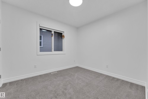 Interior room featuring light gray carpet flooring, white walls, and white baseboards - 3235 13 Avenue, Edmonton, AB - Indoor Photo Showing Other Room