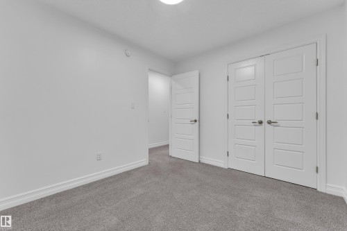 Gray carpeting with white baseboards - 3235 13 Avenue, Edmonton, AB - Indoor Photo Showing Other Room