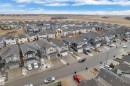 Aerial perspective of a contemporary residential neighborhood featuring two-story homes with attached garages, dark shingle roofs, and light-toned siding - 3235 13 Avenue, Edmonton, AB  - Outdoor With View 