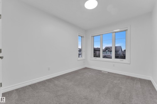 Room featuring gray carpet, white baseboards, and white walls - 3235 13 Avenue, Edmonton, AB - Indoor Photo Showing Other Room