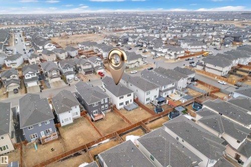 Aerial perspective highlighting the property within a residential development, featuring a fenced backyard - 3235 13 Avenue, Edmonton, AB - Outdoor With View