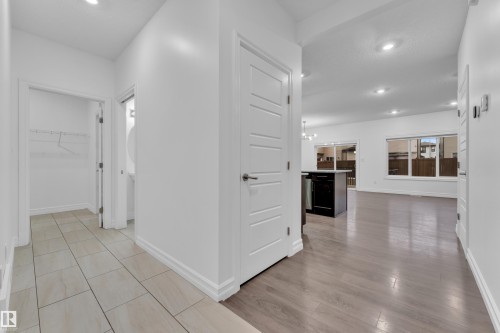 Open-concept interior featuring wood-finish flooring, recessed lighting, and white trim throughout - 3235 13 Avenue, Edmonton, AB - Indoor Photo Showing Other Room