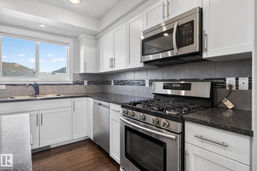 soft close cabinetry, new tile and laminate countertops - 332 Nelson Drive, Spruce Grove, AB - Indoor Photo Showing Kitchen With Double Sink With Upgraded Kitchen