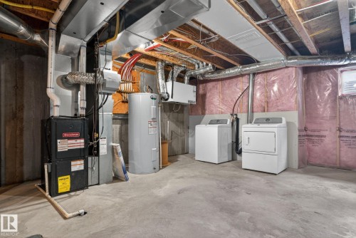 Unfinished basement with concrete flooring and exposed ceiling joists - 332 Nelson Drive, Spruce Grove, AB - Indoor Photo Showing Laundry Room