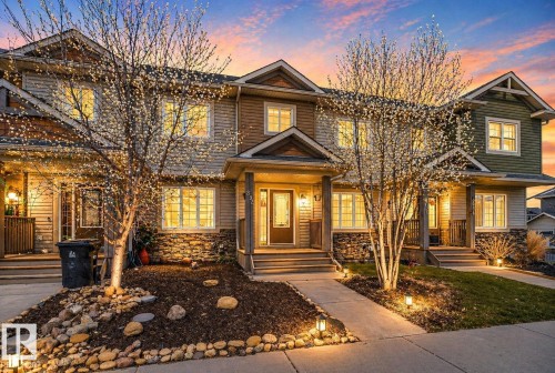 Townhome exterior featuring horizontal siding and stone veneer accents - 332 Nelson Drive, Spruce Grove, AB - Outdoor With Facade