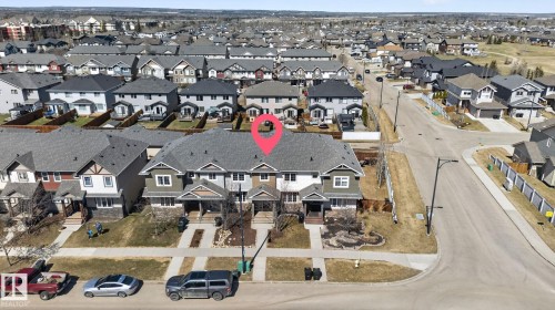 Townhome exterior featuring varied siding materials, attached garages, and individual front walkways - 332 Nelson Drive, Spruce Grove, AB - Outdoor With View