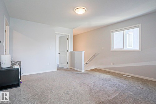 Carpeted interior space with light gray walls - 4314 Cooke Lane, Edmonton, AB - Indoor Photo Showing Other Room