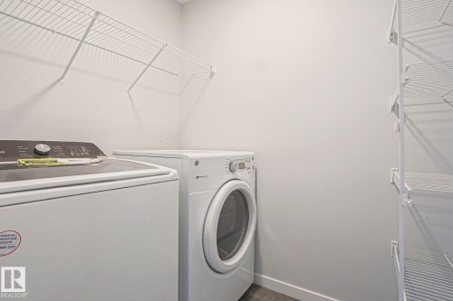 Utility area featuring white wire shelving - 4314 Cooke Lane, Edmonton, AB - Indoor Photo Showing Laundry Room