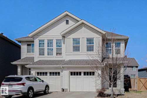 Contemporary multi-level residence featuring light-toned siding and a prominent gabled roofline - 4314 Cooke Lane, Edmonton, AB - Outdoor With Facade