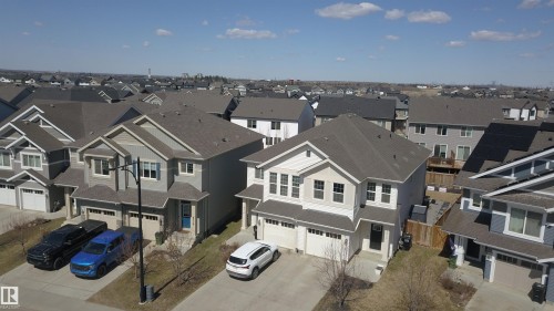 Modern residential development featuring a collection of detached homes with attached garages - 4314 Cooke Lane, Edmonton, AB - Outdoor With Facade