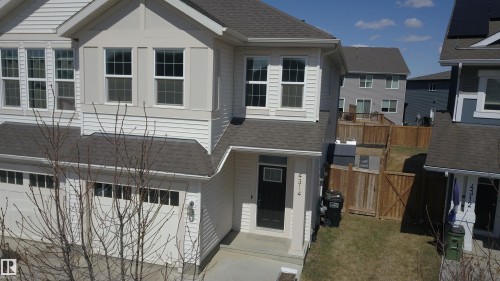 Two-story residence featuring white siding and a dark roof - 4314 Cooke Lane, Edmonton, AB - Outdoor