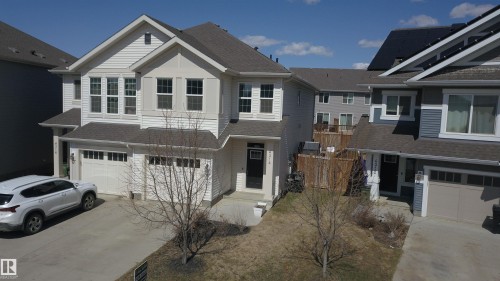 Two-story residence featuring light-colored siding and a dark shingle roof - 4314 Cooke Lane, Edmonton, AB - Outdoor