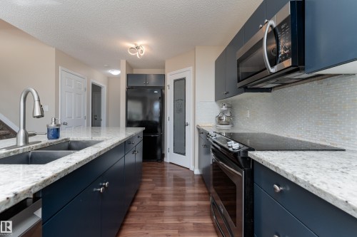 Updated cabinets, new microwave and dishwasher, walk-in pantry - 1019 177 Street, Edmonton, AB - Indoor Photo Showing Kitchen With Double Sink With Upgraded Kitchen