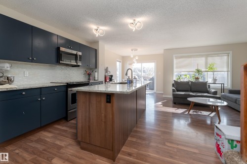 Open concept floor plan, kitchen island w/ granite countertops, extra windows. - 1019 177 Street, Edmonton, AB - Indoor Photo Showing Kitchen