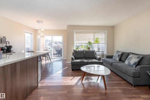 Open concept floor plan, kitchen island w/ granite countertops, extra windows. - 1019 177 Street, Edmonton, AB - Indoor Photo Showing Living Room