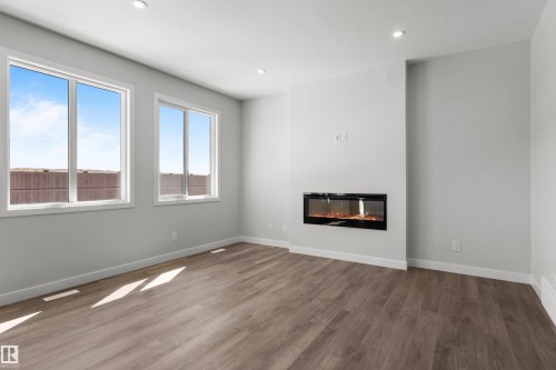 287 Paterson Link Link, Edmonton, AB - Indoor Photo Showing Other Room With Fireplace