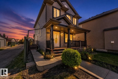 Two-story exterior featuring horizontal siding and dark shingle accents - 1921 119A Street, Edmonton, AB - Outdoor With Deck Patio Veranda