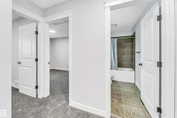 Bathroom with a full tub and shower, complemented by square floor tiling - 
