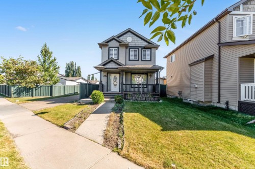 Inviting two-story residence with a gray exterior, dark trim accents, and a covered front porch - 1921 119A Street, Edmonton, AB - Outdoor With Deck Patio Veranda