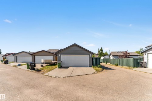 Detached garage with horizontal siding and a white overhead door - 1921 119A Street, Edmonton, AB - Outdoor