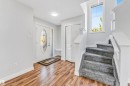 Bright foyer featuring wood-finish flooring and a staircase with grey carpeted treads - 1921 119A Street, Edmonton, AB  - Indoor Photo Showing Other Room 