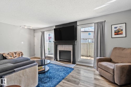 8 1020 41 Street, Edmonton, AB - Indoor Photo Showing Living Room With Fireplace