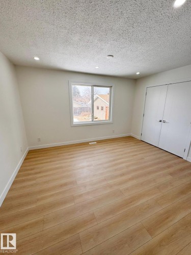 Spacious room featuring light wood-finish flooring, recessed lighting, and a neutral wall palette - 20 Hunt Road, Edmonton, AB - Indoor Photo Showing Other Room