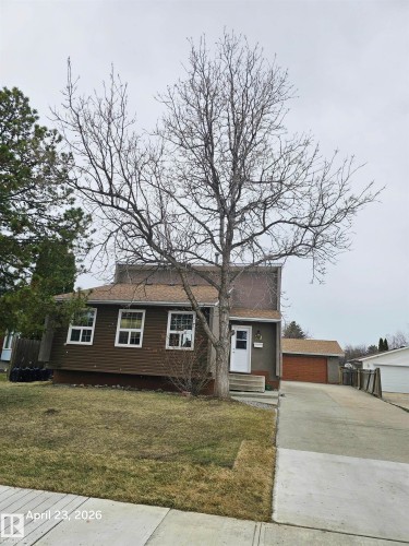 Brown siding exterior with white window frames and a white front door - 20 Hunt Road, Edmonton, AB - Outdoor