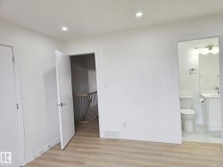 Room featuring wood-finish flooring, recessed ceiling lighting, and crisp white walls - 