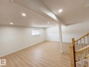 Spacious lower-level room featuring light wood-finish flooring, recessed lighting, and a neutral color palette - 20 Hunt Road, Edmonton, AB  - Indoor 
