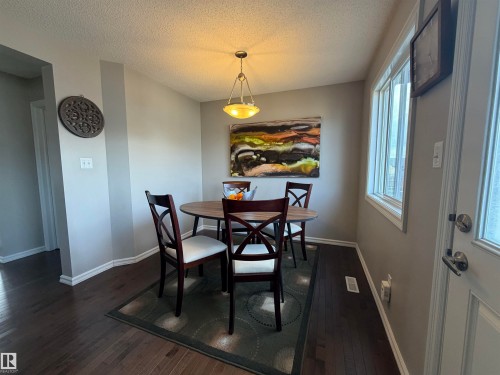 Defined dining space featuring dark wood-finish flooring - 5204 4 Avenue, Edmonton, AB - Indoor Photo Showing Dining Room
