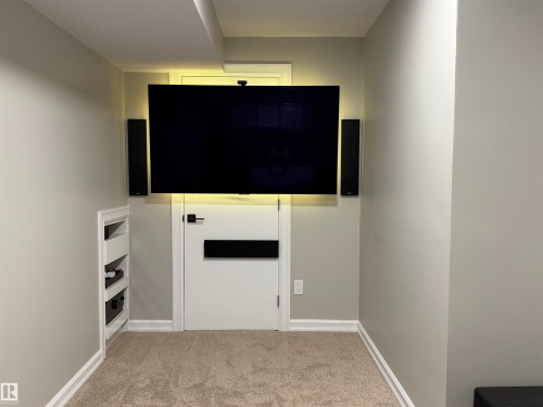 Media wall featuring a mounted screen, integrated speakers. - 5204 4 Avenue, Edmonton, AB - Indoor Photo Showing Other Room