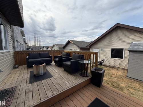Spacious outdoor deck featuring natural wood flooring and a wooden railing - 5204 4 Avenue, Edmonton, AB - Outdoor With Deck Patio Veranda With Exterior
