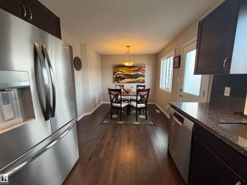 Kitchen and dining area featuring wood-finish flooring - 5204 4 Avenue, Edmonton, AB - Indoor Photo Showing Kitchen
